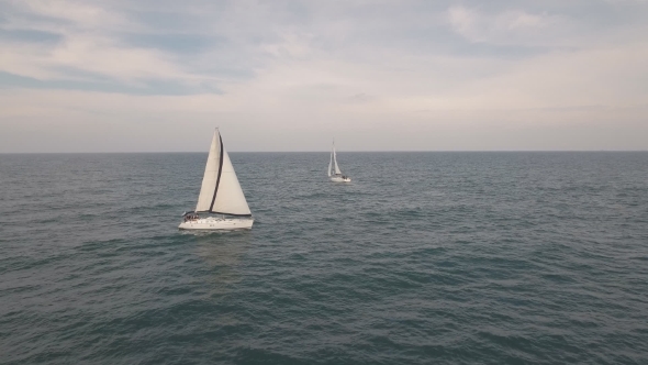 motorboat approaching sailboat head on