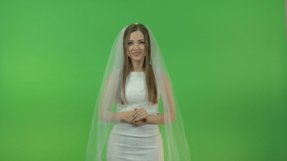 Young White Girl in a Bride Dress, on a Green Background.