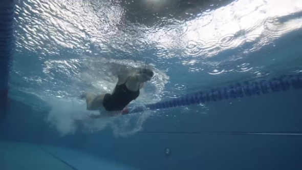 Woman Floating Butterfly Stroke In Swimming Pool Underwater , Stock Footage