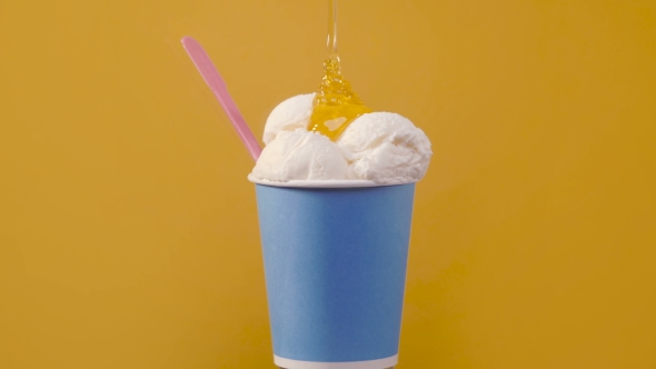 Soft Vanilla Ice Cream in Blue Paper Cup with Sweet Topping