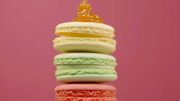 Stack of Colorful Rotating Macaroons on Color Background