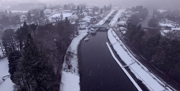 Aerial over River while Snowing in Scotland