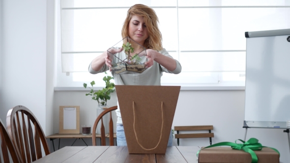 Florist Woman Packing Florarium in a Card Box