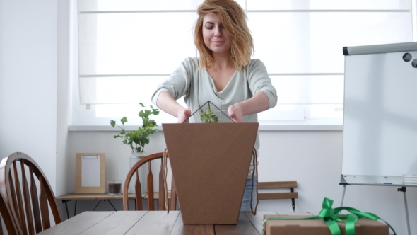 Florist Woman Packing Florarium in a Card Box.