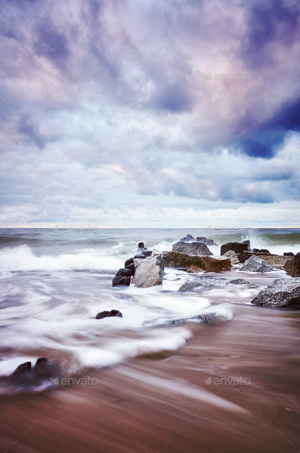 Color toned picture of an empty beach with blurred water. - Stock Photo - Images