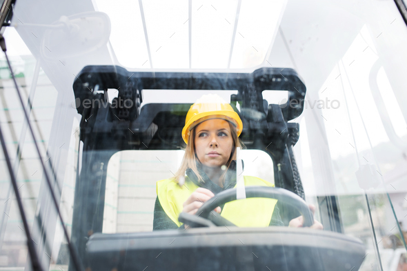 Woman forklift truck driver in an industrial area. - Stock Photo - Images