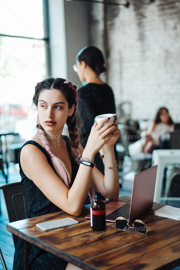 Young woman sitting in coffee shop Stock Photo by simbiothy | PhotoDune