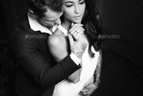Beautiful, young couple posing on camera indoors - Stock Photo - Images