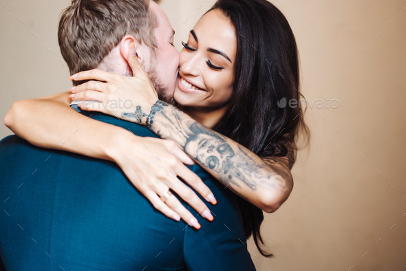 Beautiful, young couple posing on camera indoors - Stock Photo - Images