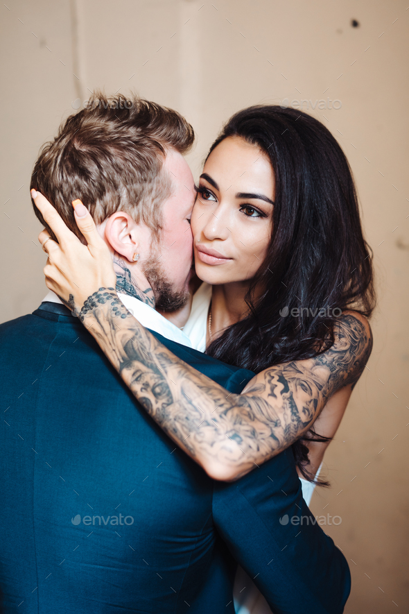 Beautiful, young couple posing on camera indoors - Stock Photo - Images