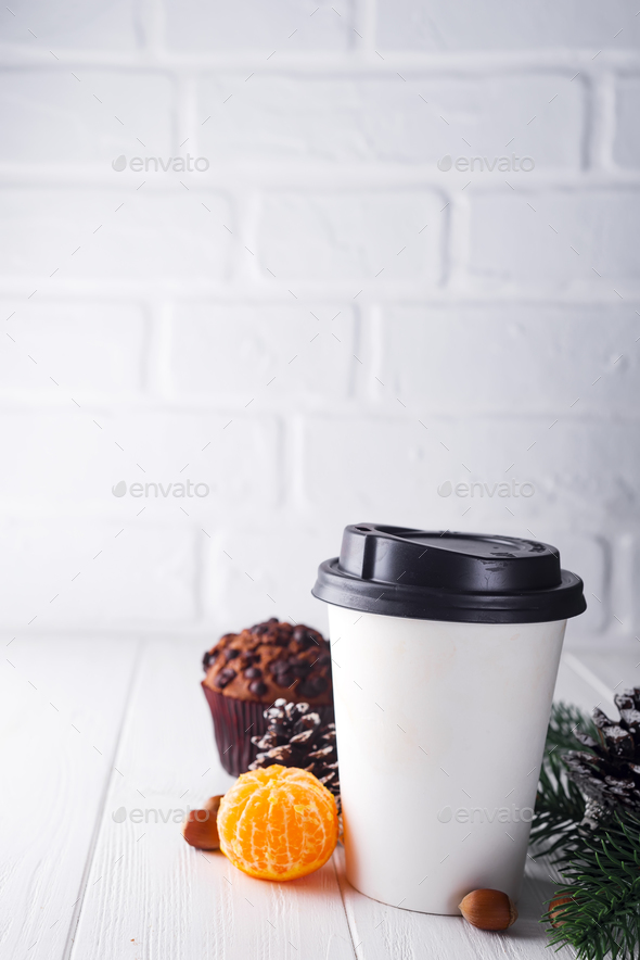 Paper cup of coffee surrounded by Christmas decorations - Stock Photo - Images
