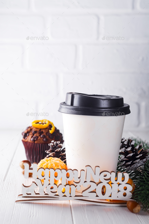 Paper cup of coffee surrounded by Christmas decorations - Stock Photo - Images
