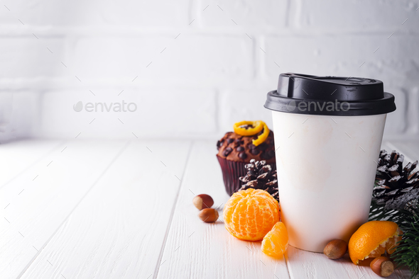Paper cup of coffee surrounded by Christmas decorations - Stock Photo - Images