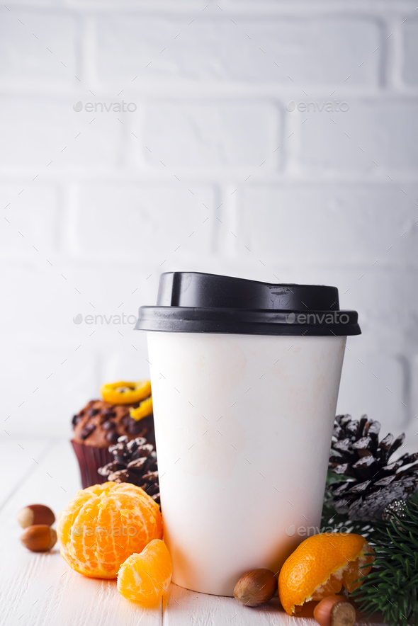 Paper cup of coffee surrounded by Christmas decorations - Stock Photo - Images
