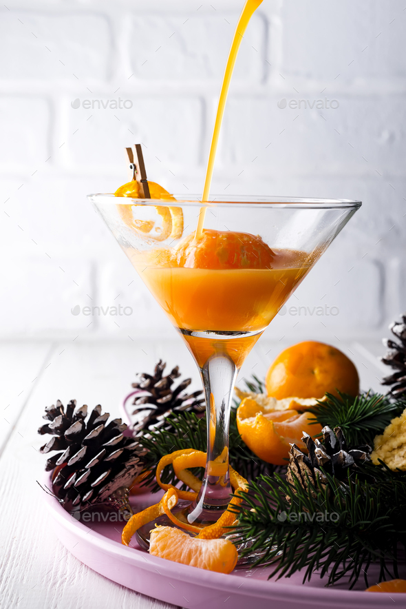 pour a cocktail martini in a glass of New Year - Stock Photo - Images