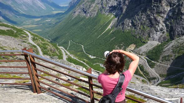 Tourist With Camera On Trollstigen Viewpoint alt