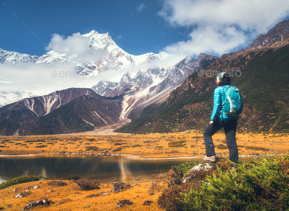 Landscape with girl, high rocks with snowy peaks - Stock Photo - Images
