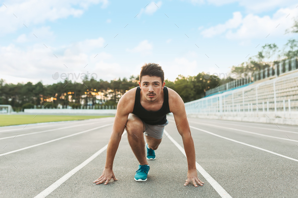 Young sportsman is ready to run outdoors in the morning. - Stock Photo - Images