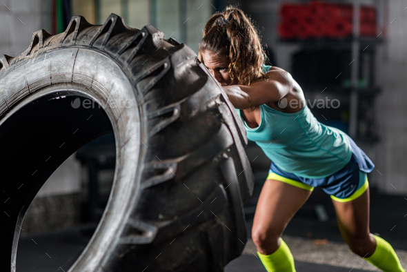 Woman athlete exercising with tire - Stock Photo - Images