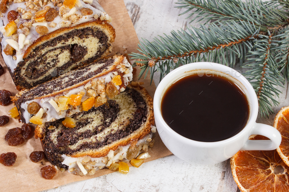 Poppy seeds cake, cup of black coffee and spruce branches, dessert for Christmas - Stock Photo - Images