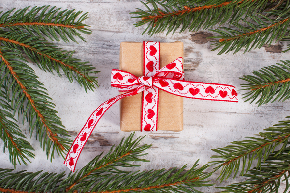 Wrapped gift with ribbonand spruce branches for Christmas or Valentines - Stock Photo - Images