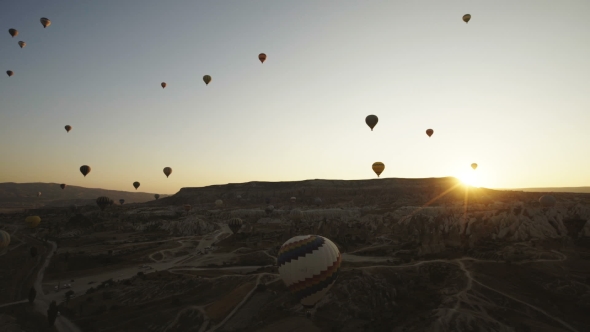 Colorful Hot Air Balloons Flying Over Red Valley at Cappadocia on Sunset alt