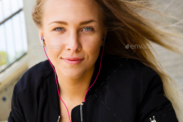 Close Portrait of Blonde Woman In Sportswear Listening To Music - Stock Photo - Images