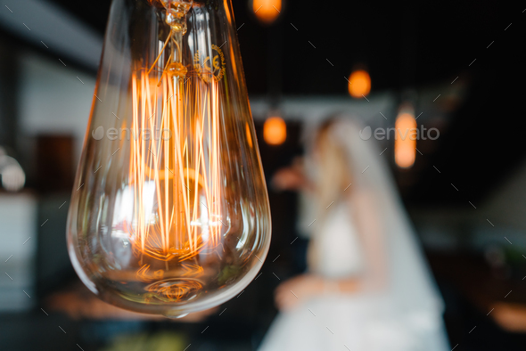 retro bulbs lights. newlyweds couple embracing - Stock Photo - Images