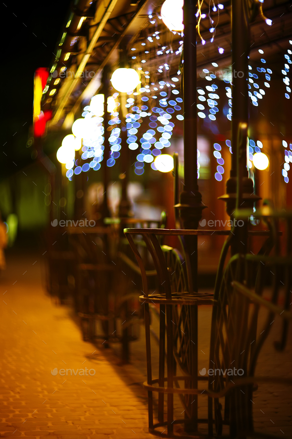 Fences and blurred night lights decorations of the bar on backgr