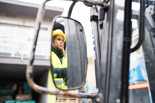 Woman forklift truck driver in an industrial area. - Stock Photo - Images
