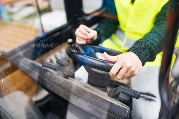Woman forklift truck driver in an industrial area. - Stock Photo - Images