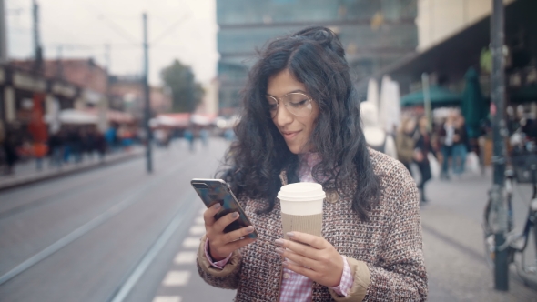 A Girl of Oriental Appearance Waits for a Tram at the AlexanderPlatz Transport Stop in Berlin and alt
