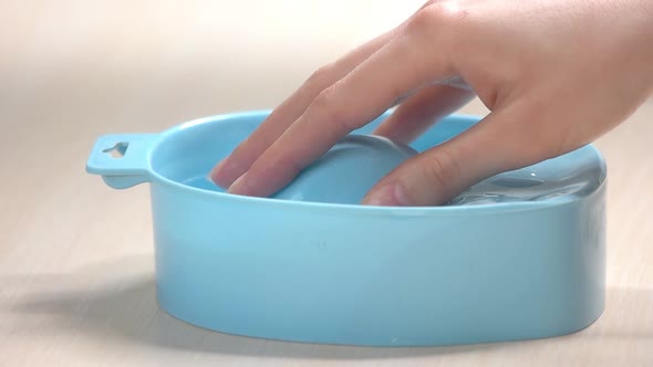 Hand Placing in Bowl with Water, Slow Motion. alt