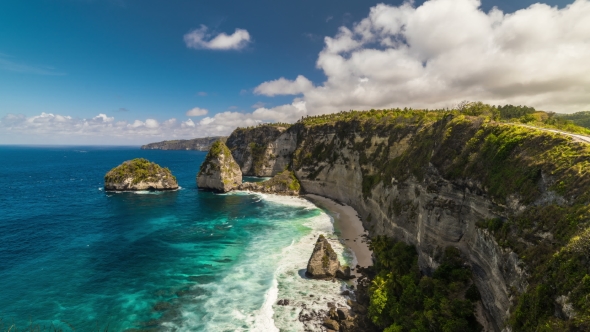 Rocky Coast with Big Waves and Clouds at Nusa Penida Island, Indonesia alt