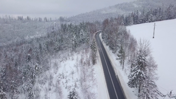 Majestic View of Road in Snowy Mountains alt