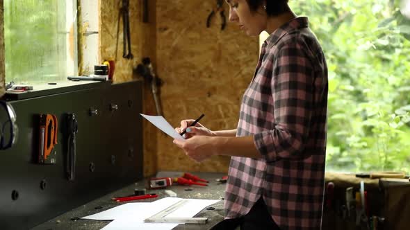 Woman Architect Check Plan of New Apartment Design at Workshop