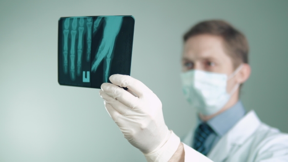 the Doctor Is Engaged in His Work in the Hospital Examines an X-ray of the Hand an Ambulance To alt