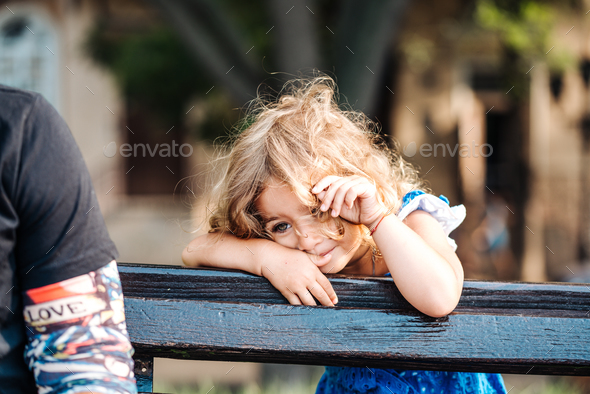 toddler girl standing behind a bench Stock Photo by simbiothy | PhotoDune
