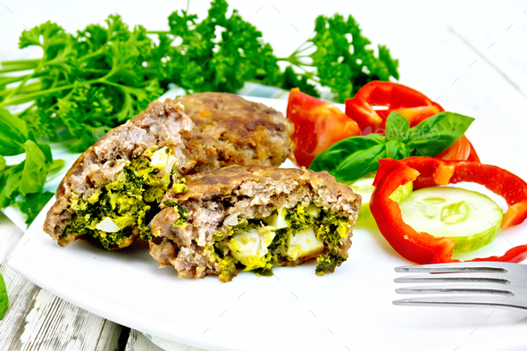 Cutlets stuffed in plate on board - Stock Photo - Images