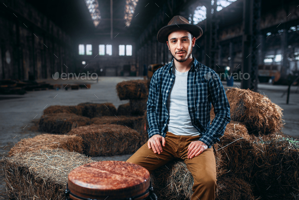 Young male drummer against african wooden drum - Stock Photo - Images