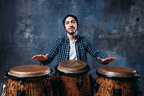 Drummer playing on wooden bongo drums, beat music - Stock Photo - Images