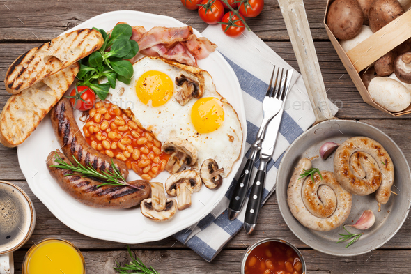 English breakfast. Fried eggs, sausages, bacon - Stock Photo - Images
