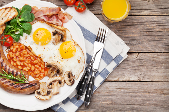 English breakfast. Fried eggs, sausages, bacon - Stock Photo - Images