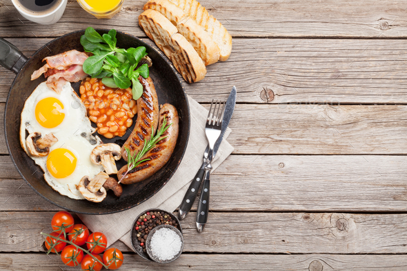 English breakfast. Fried eggs, sausages, bacon - Stock Photo - Images
