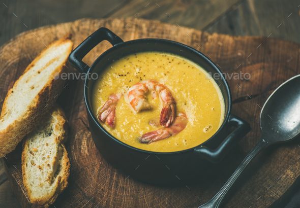 Corn creamy soup with shrimps served in pot - Stock Photo - Images