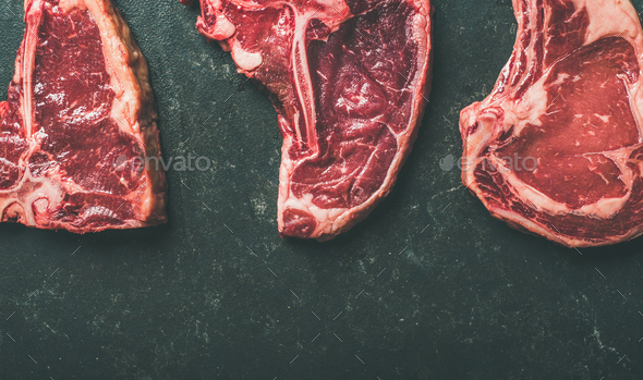 Porterhouse, t-bone and rib-eye steaks over black background - Stock Photo - Images