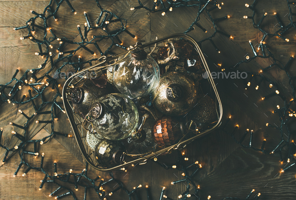 Christmas decoration balls in box and holiday light garland - Stock Photo - Images