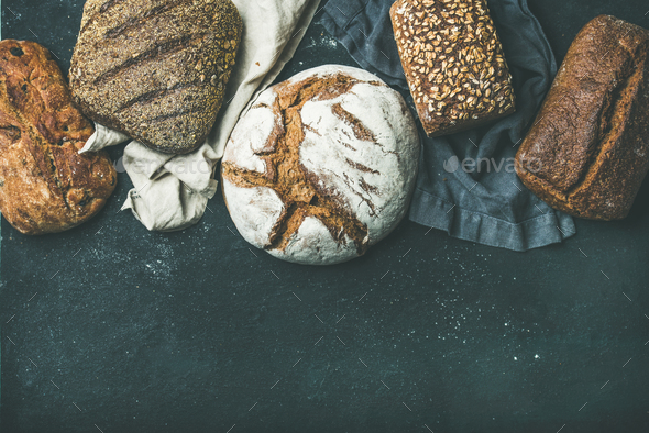 Various bread selection flat-lay, black background, copy space - Stock Photo - Images