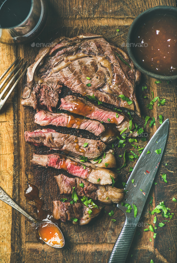 Grilled medium rare ribeye beef steak with red wine, flat-lay - Stock Photo - Images