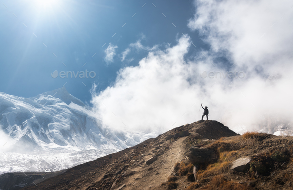 Young woman with raised up arms on the mountain peak - Stock Photo - Images